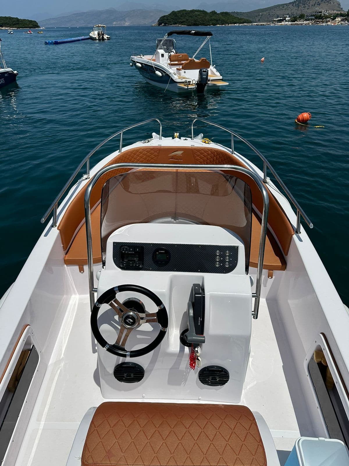 The Ksamili Boat Hire fleet at the dock, captain's own photograph, golden Ionian light