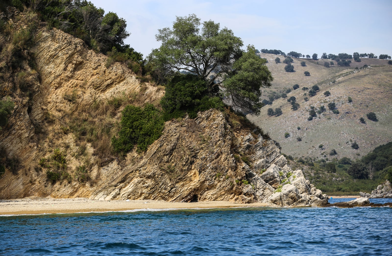 Tongo, a small rocky islet off Cape Stillo, clear water around it