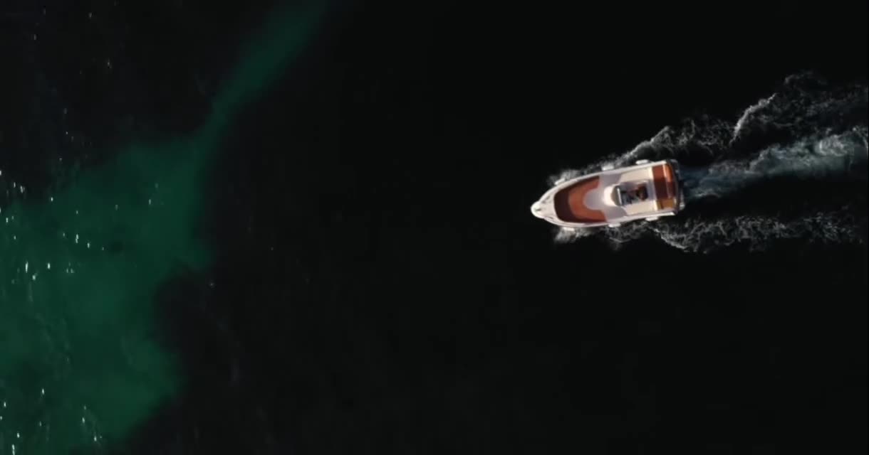 Drone: white wake into emerald shallows