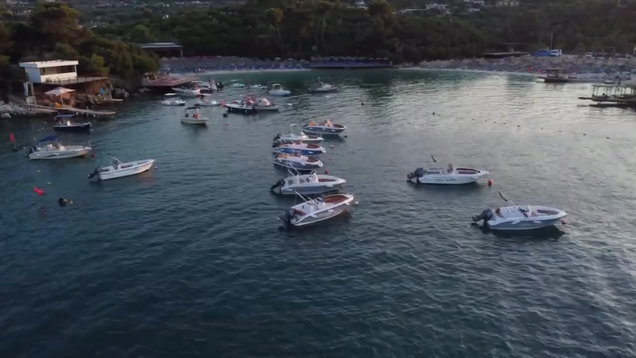 Golden-hour cove full of anchored boats